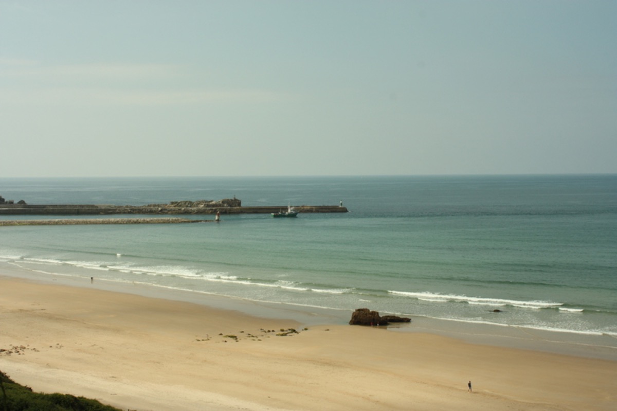 Barco saliendo rompeolas playa Merón, San Vicente de la Barquera, Cantabria